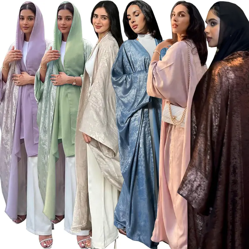 Muslim fashion abaya with gold embroidery worn as an outer jacket over the long robe.