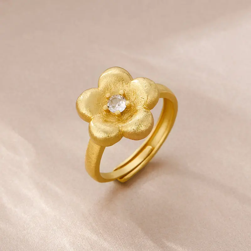 A delicate and luxurious ring with a zircon flower center, featuring twisted plum petals in gold color, with a movable shank for easy wear, simple yet retro, versatile and elegant.
