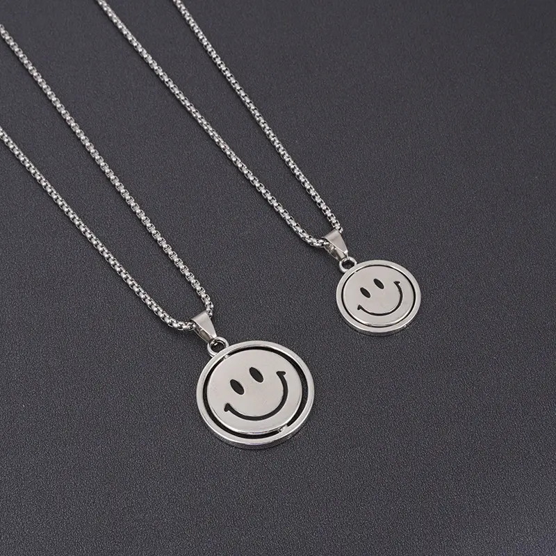 Titanium steel rotating smiling face necklace, hip-hop pendant, personalized, simple and versatile crying face pendant