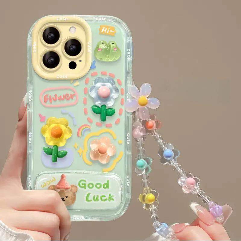XBD Ốp Điện Thoại Búp Bê Hoa Ếch Tương Thích Với iPhone 17 16 16E 15 14 13 12 Pro Max 17Air 16 15 14 Plus Ốp Lưng Chống Sốc Màu Kem Thạch Có Gương nhỏ Chân Đế Gập Và Vòng Tay