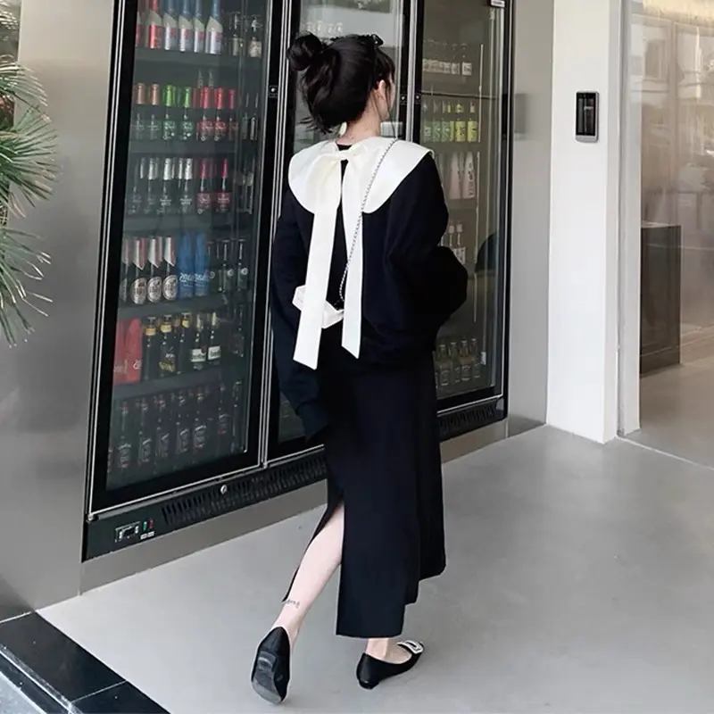 Set áo dài tay đen nơ lưng, chân váy dài
