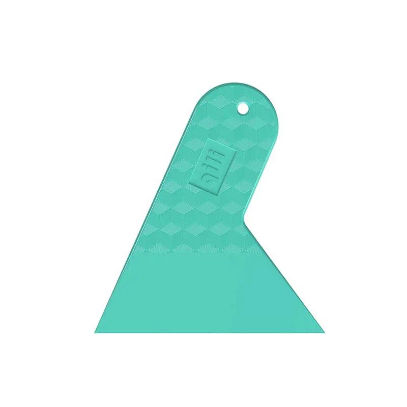 Bright colored car window film with triangular tips and a razor blade ...