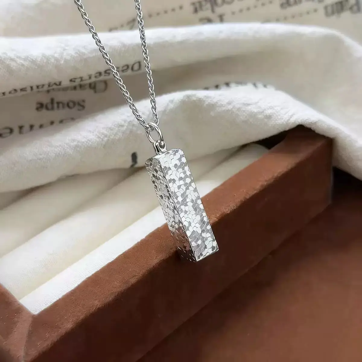 A new small Chinese style gold bar pendant adorned with ice 