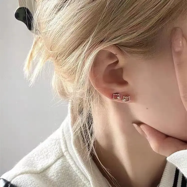 The lady's earrings are kt cat earrings