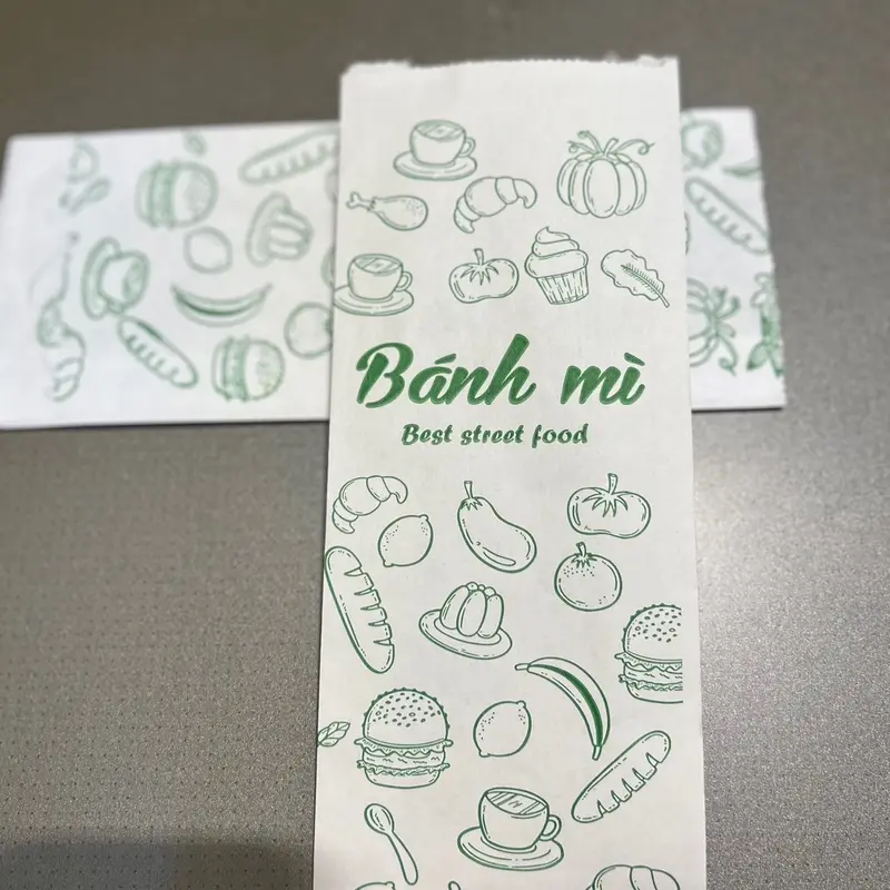 1.500 Túi đựng bánh mì trắng in xanh S1- kích thước 95x50x245 giấy  gói 1