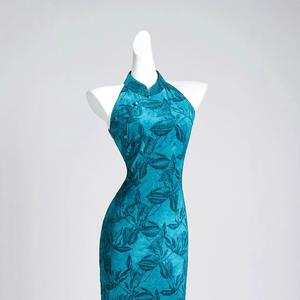 New Chinese style long dress, cheongsam, blue-green color with bright prints. Traditional style long dress, stand-up collar, retro buttons.