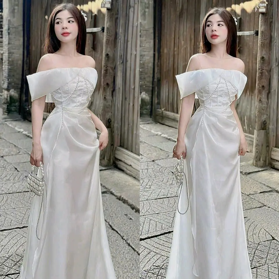 Đầm trắng dài trễ vai phối gấm nhún hông