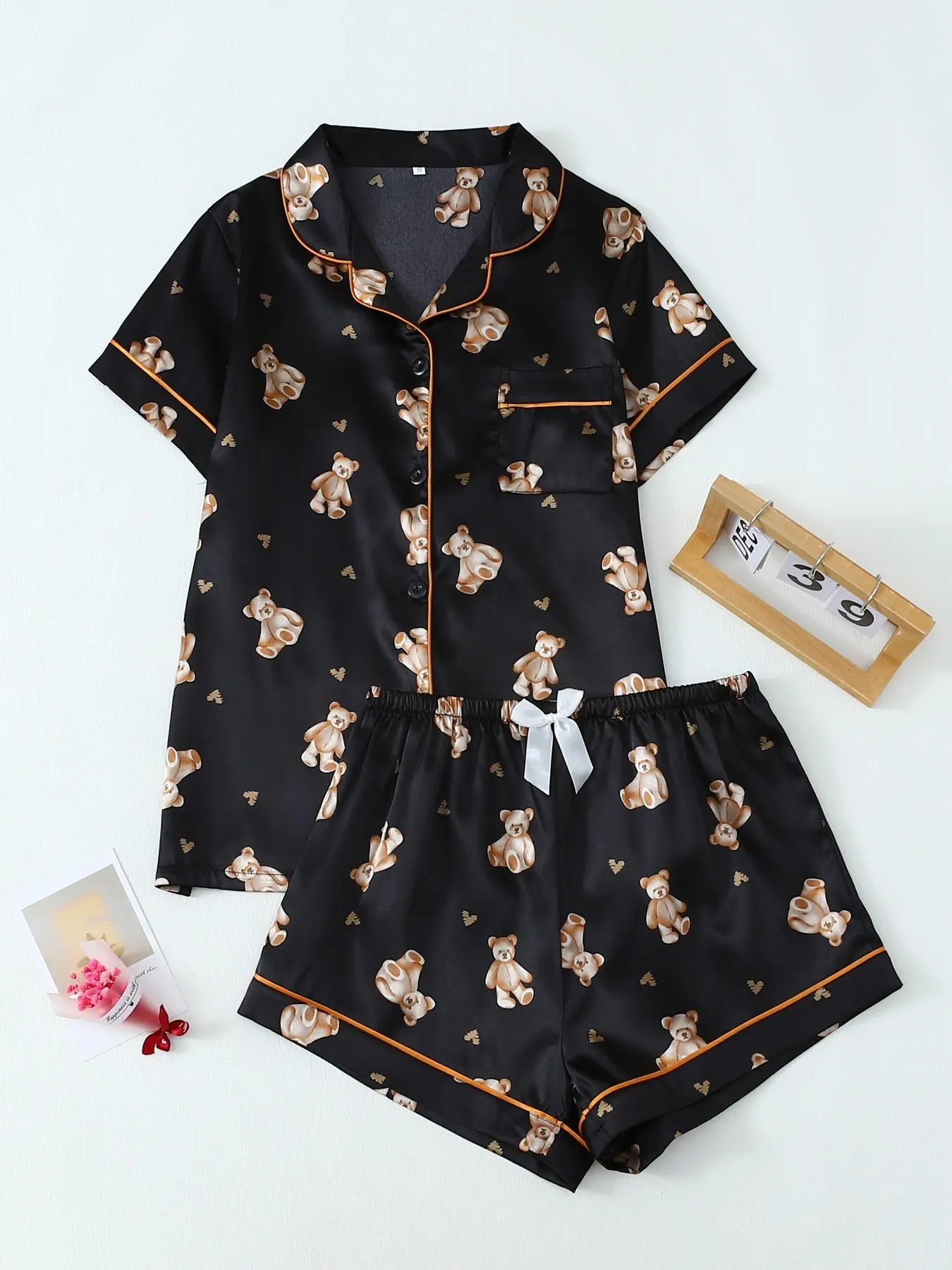 Women's All Over Cartoon Teddy Bear Print Short Sleeve Satin Pajama Two-Piece Set, Elegant Casual Comfy Button Front Chest Pocket Design Lapel Neck Top & Bow Decor Elastic Waist Shorts PJ Set, Ladies Sleepwear for All Seasons