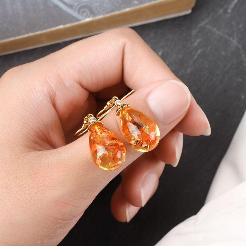 Product Introduction of Natural amber floral earrings, fashionable and versatile women's earrings, ethnic style earrings, pure silver ancient gold ear hooks 0
