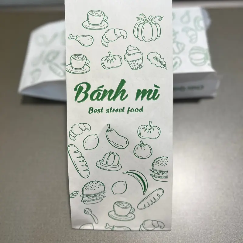 1.500 Túi đựng bánh mì trắng in xanh S1- kích thước 95x50x245 giấy  gói 0