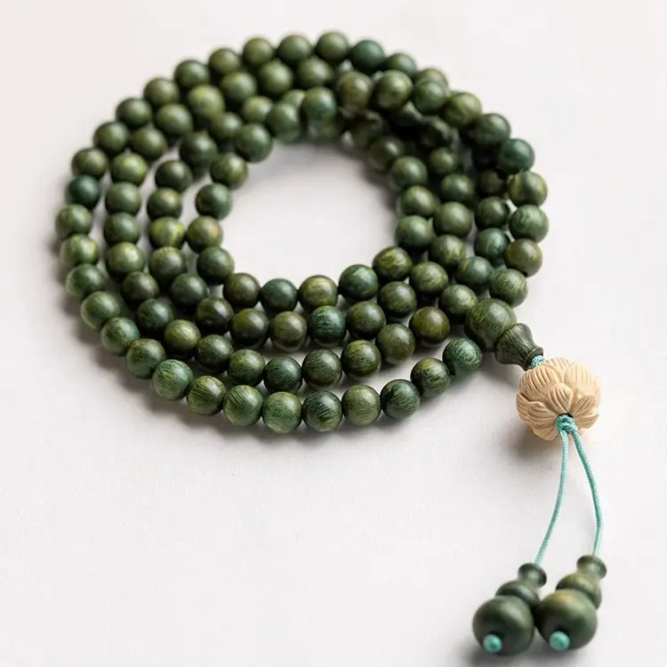 Green sandalwood bracelets are strung multiple times to transport prayer beads.